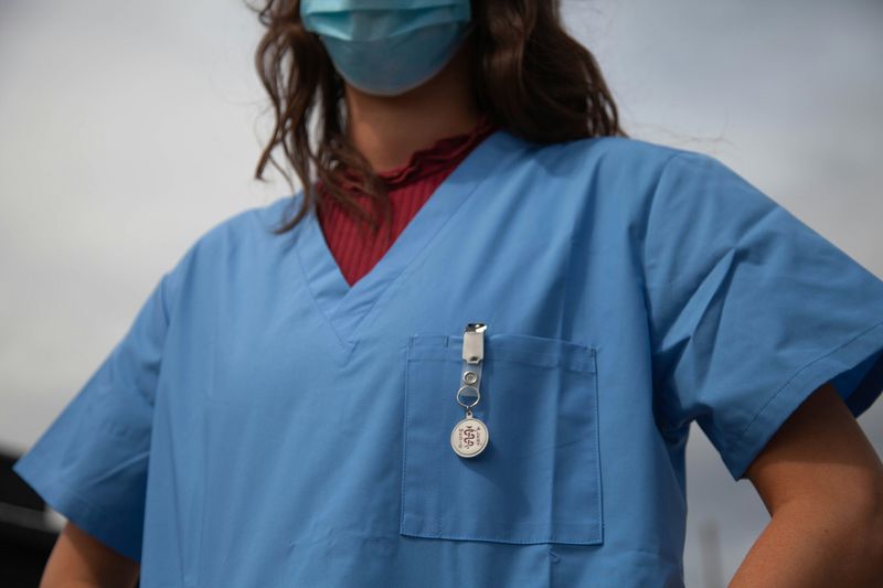 A healthcare worker in scrubs.