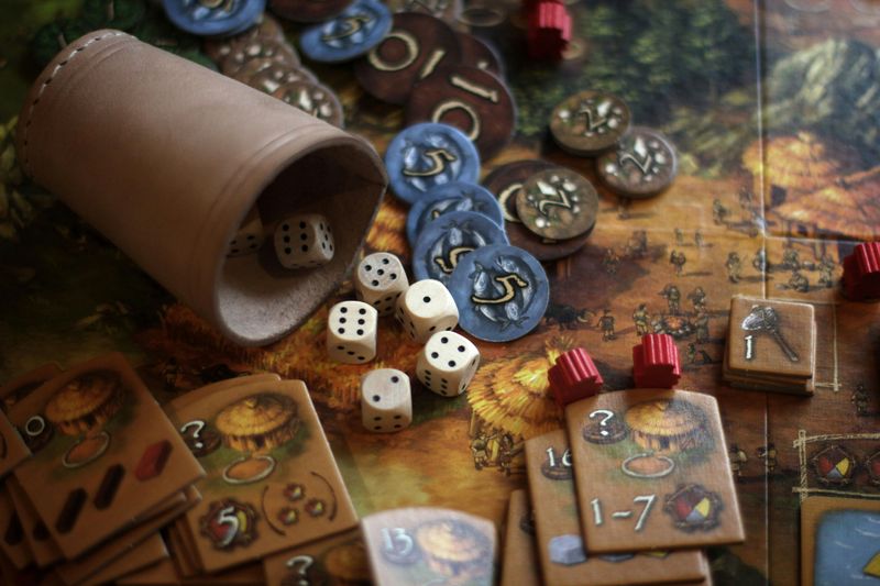 A farming themed board game with cards, dice, and chips.