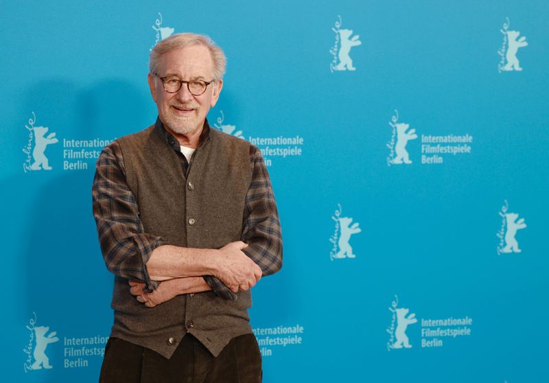 Steve Spielberg posing for cameras at a film festival.