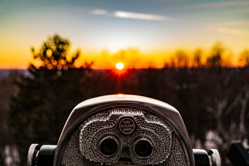 image of binoculars focused on the sunset