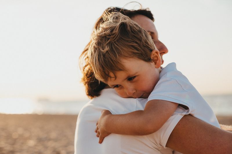 A mother holding a child in a field