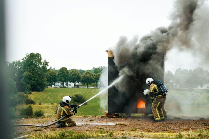 Firefighters practicing putting out a fire