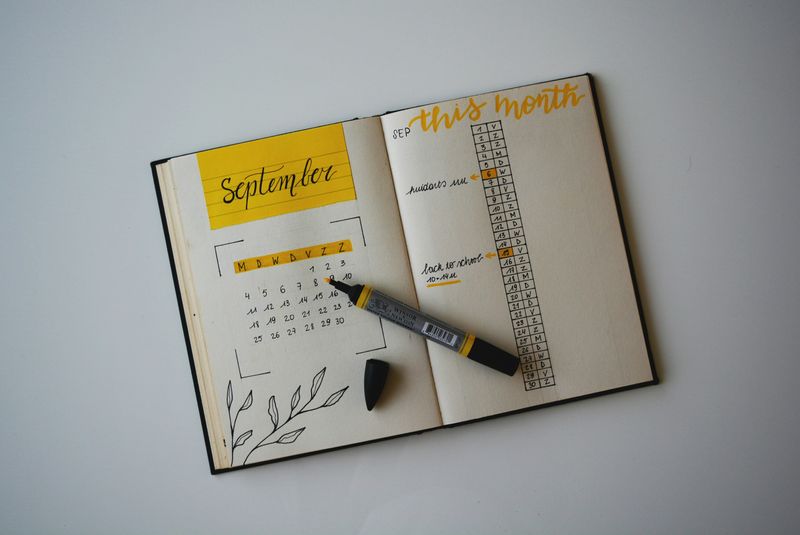 An open journal showing a calendar and monthly notes.