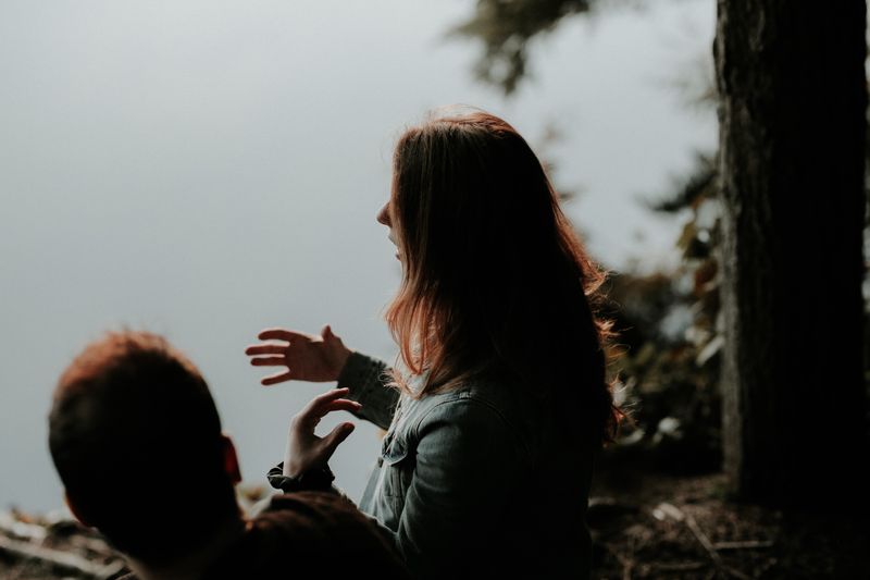 2 people interacting, woman expressing through hand gestures