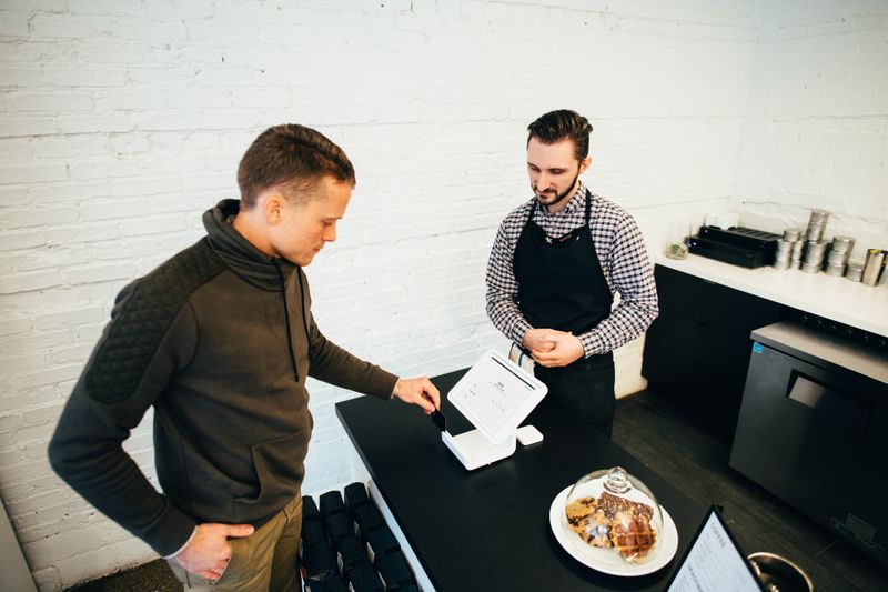 A customer buying food at a cafe