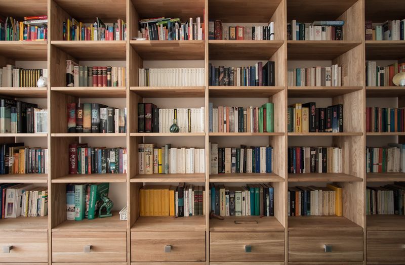 Tall bookshelf unit, with six drawers across the bottom and six sets of five vertical shelf units stacked on the drawers.