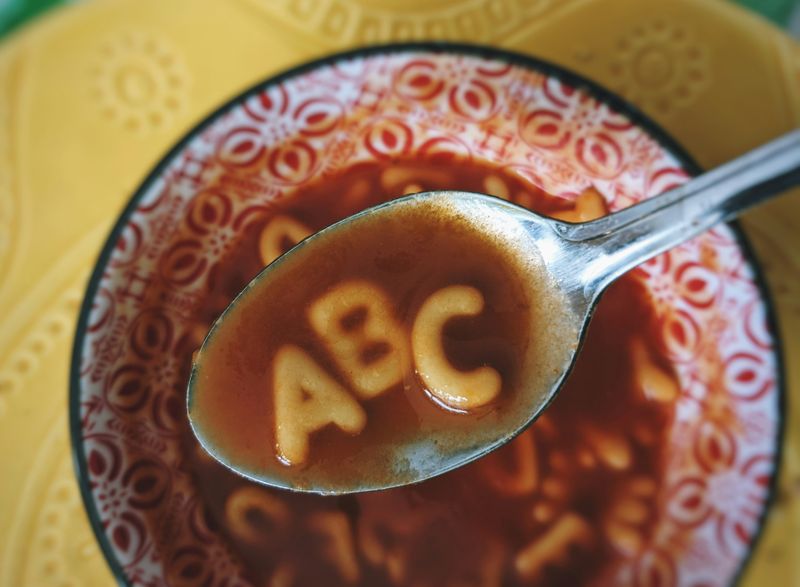 An alphabet soup in a bowl. The letters 