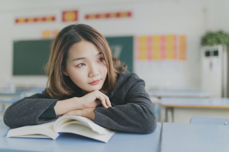 Teenage girl in a classroom reading