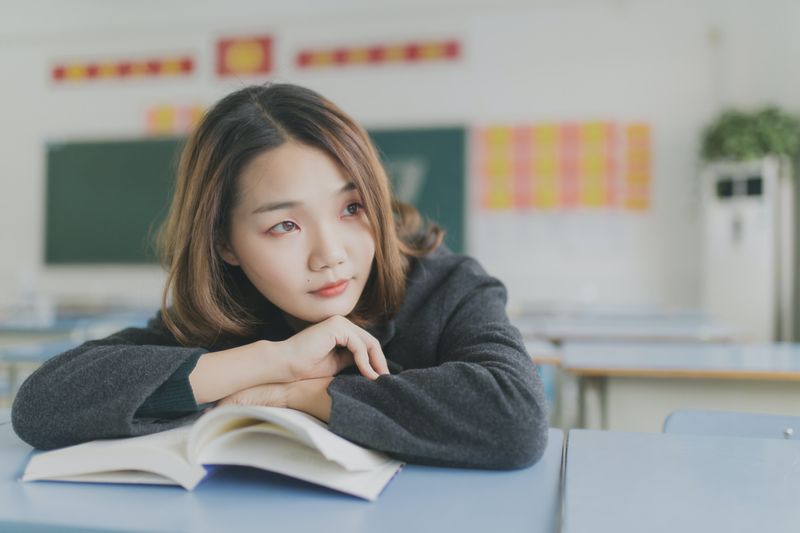 Teenage girl in a classroom reading