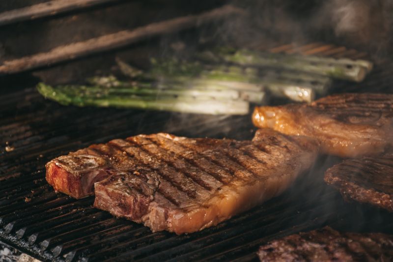 A variety of meats on a grill.