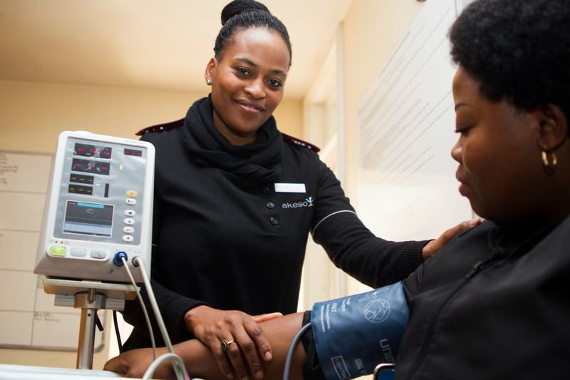 A nurse practitioner taking a patient's blood pressure.