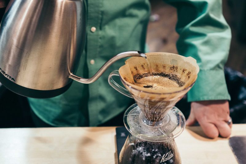 Image showing coffee poured over through a filter into a cup.