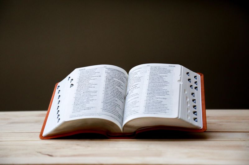 An open book, sitting on a table. 