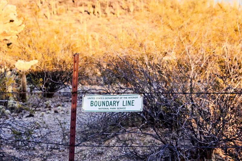 A fence with a sign that reads 'boundary line'