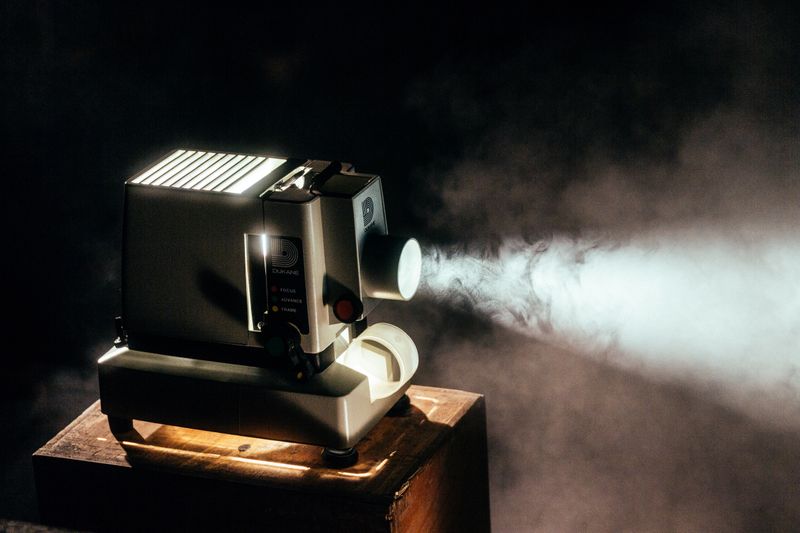 A film projector in a dark room.