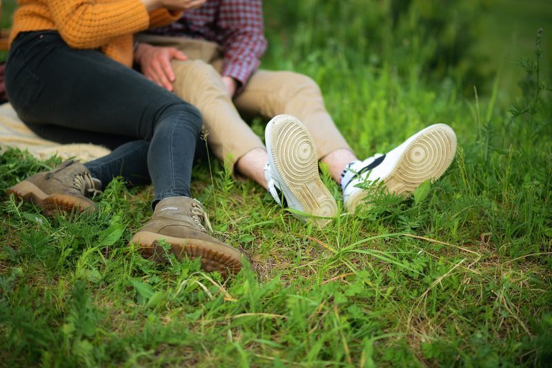 Lovers sitting in a field.