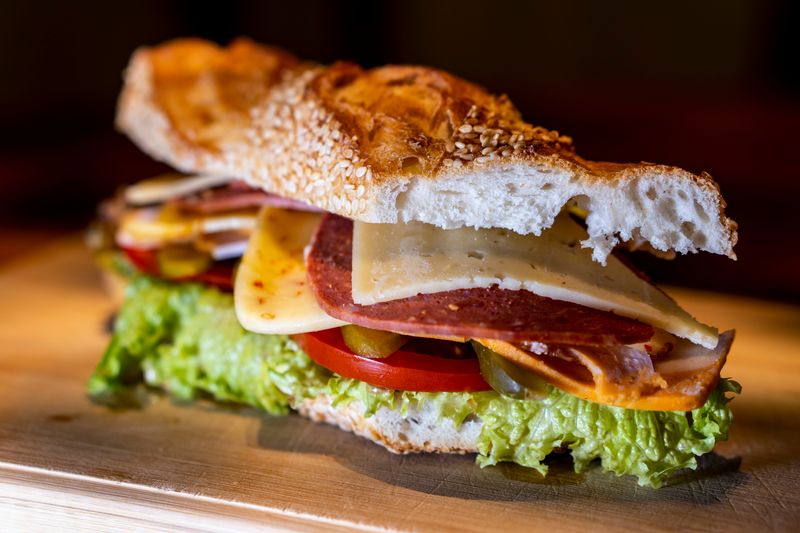 Sandwich with meat, cheese, and lettuce.