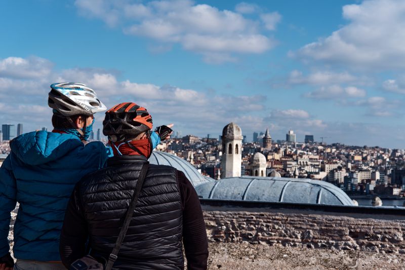 Two cyclists looking over the Istanbul skyline.