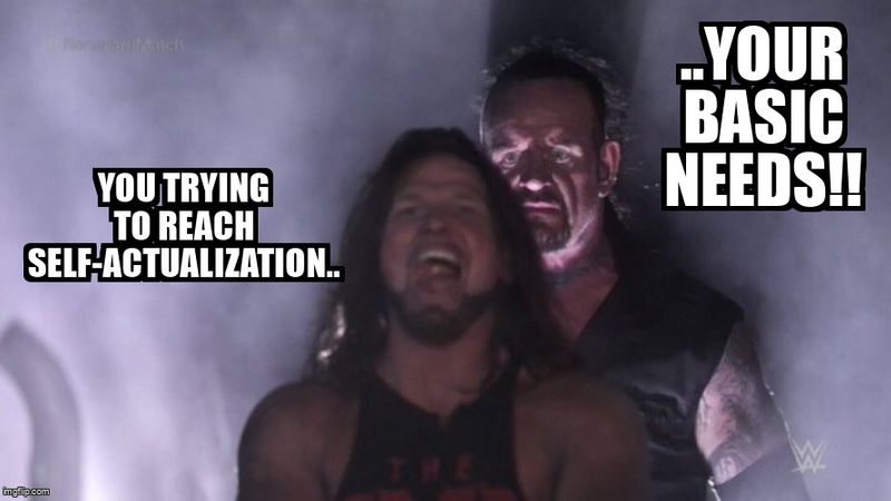 The Undertaker (labelled 'your basic needs') sneaks behind AJ Styles (labelled as 'you trying to reach self-actualization').