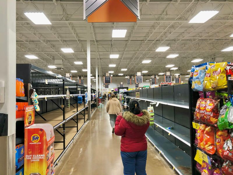 A grocery store with nearly empty shelves.