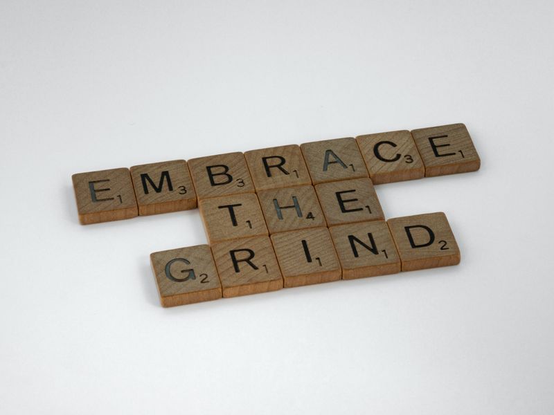 Scrabble tiles that read, 'embrace the grind'.