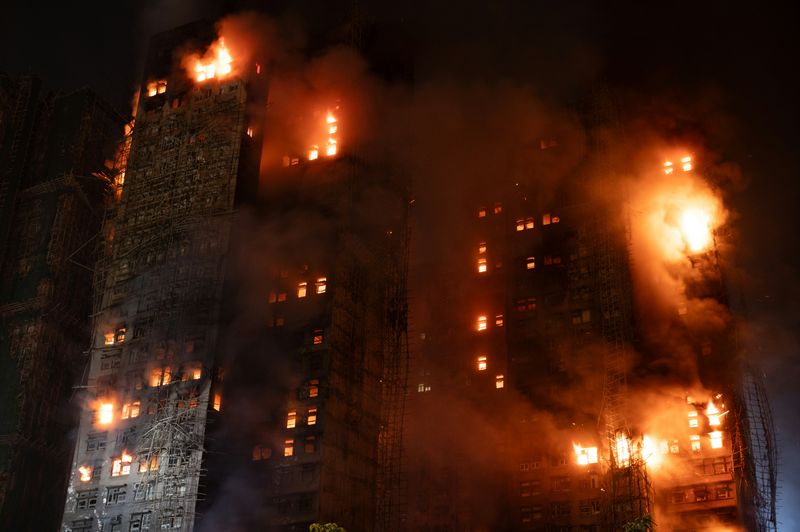Buildings burning on fire at night.
