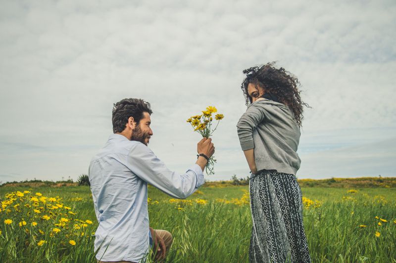 man giving woman flowers