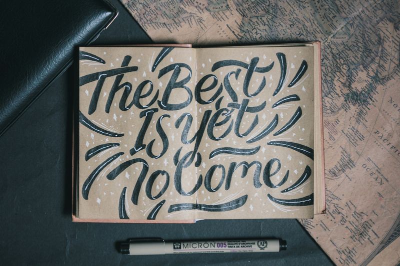 Photo: written text 'The best is yet to come' in the notebook