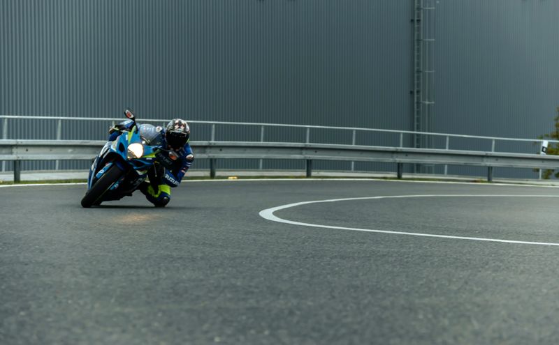 Image showing a man racing with his motorbike on a race course who is almost touching the ground