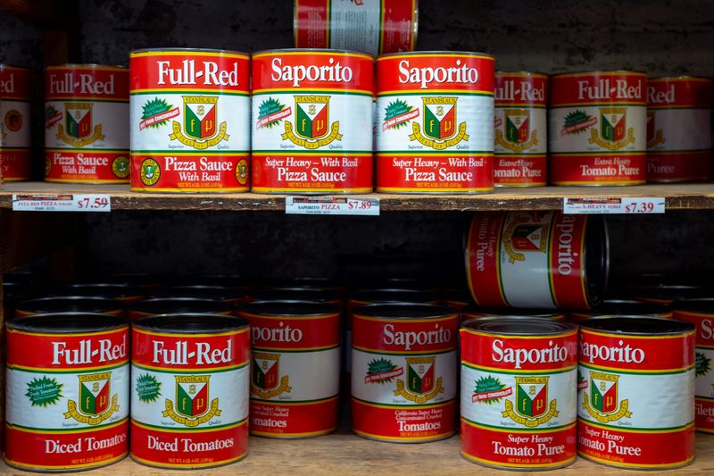 Canned tomatoes in stock on shelves.