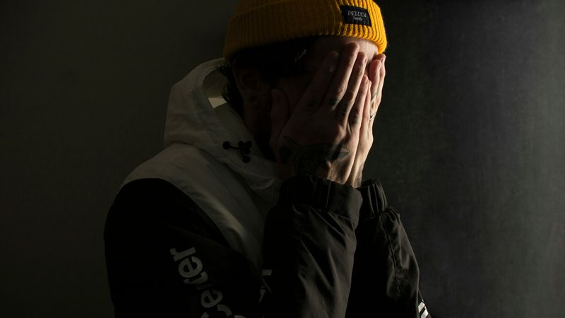 A person covering their face with their hands.