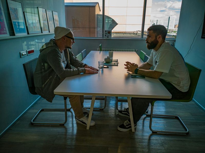 Two people meeting privately in a conference room, having a discussion.