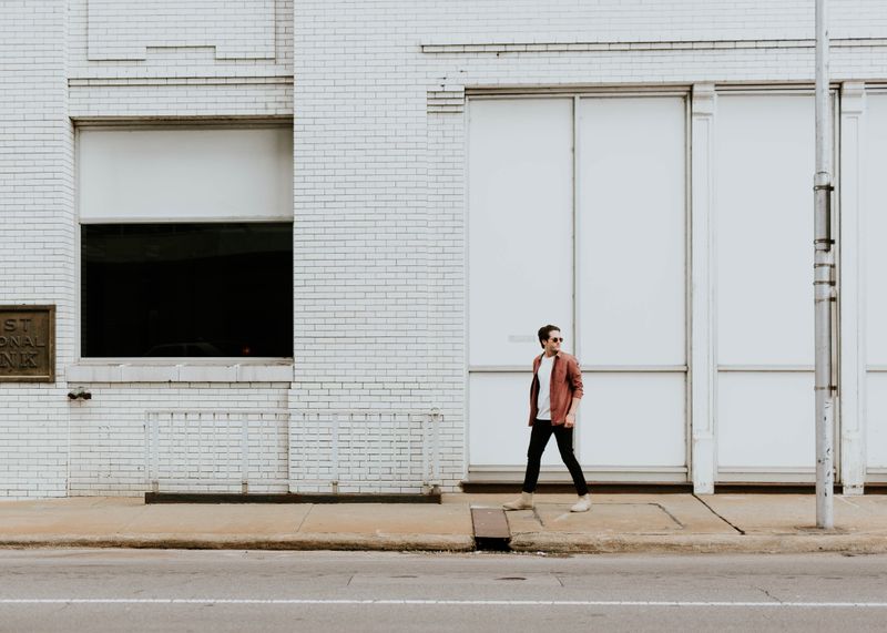 A man walking alone in a city.