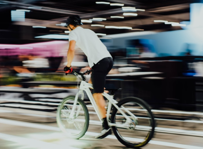 A person riding a hybrid bike through a city