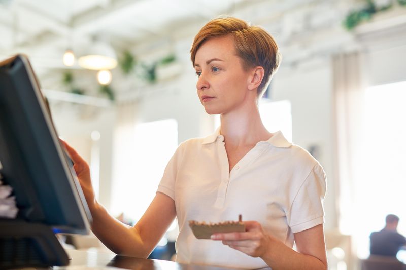 Waitress at a cash register.