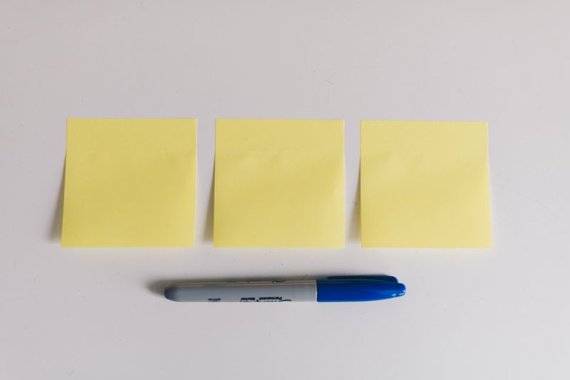 Three sticky notes with a marker
