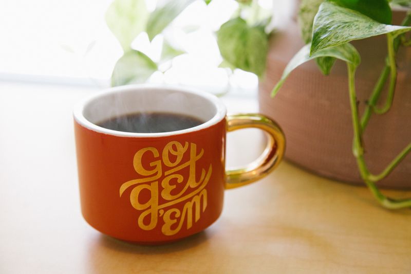 A coffee mug with the text 'go get 'em'.