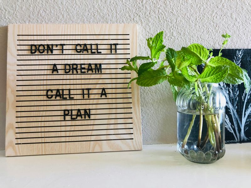 A sign on a desk that reads: "Don't call it a dream, call it a plan."