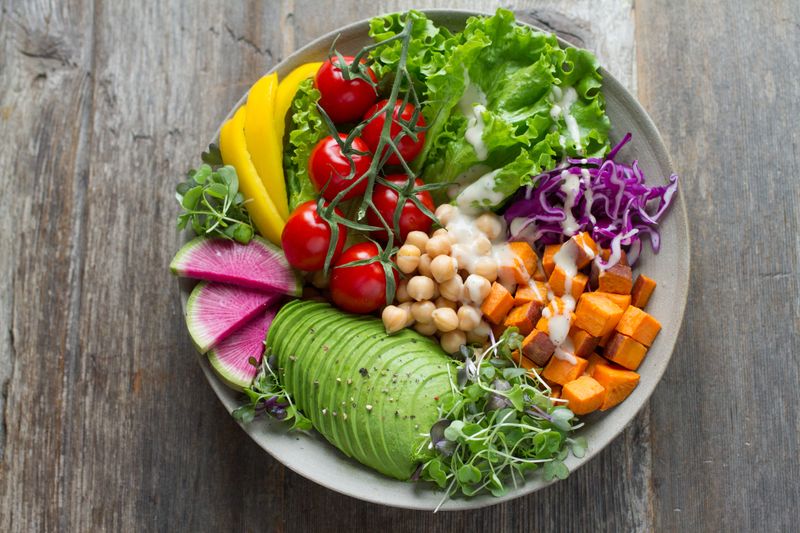 A colorful bowl of various vegetables and legumes
