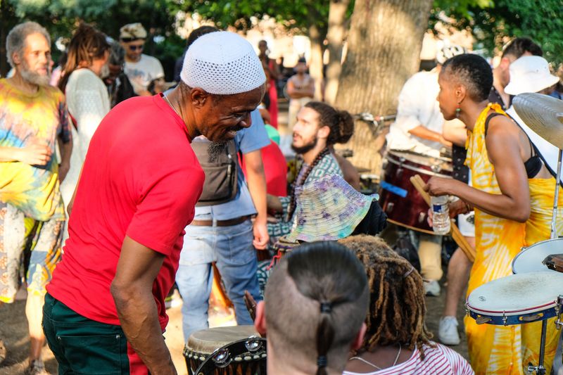 People at drum festival with many different drums.