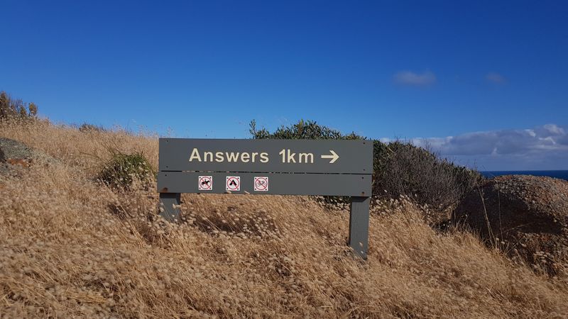 A sign that reads 'Answers 1km'.