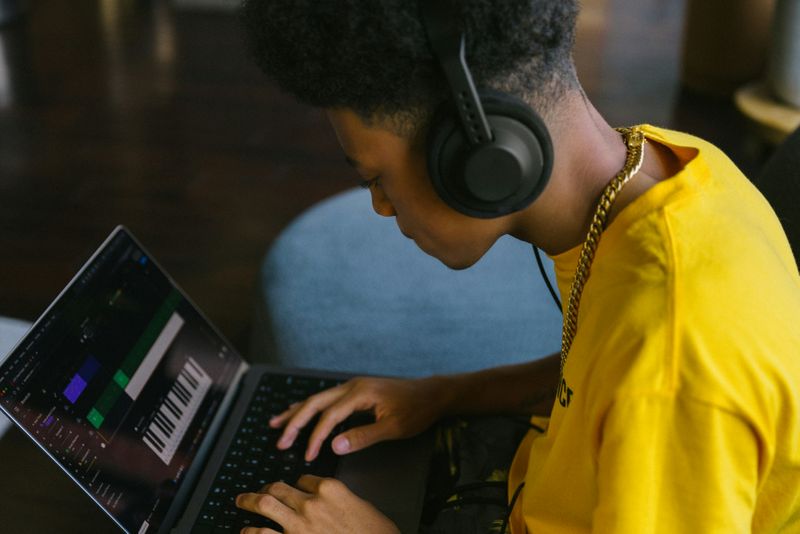 A person learning how to start making beats at home while working on a digital audio.