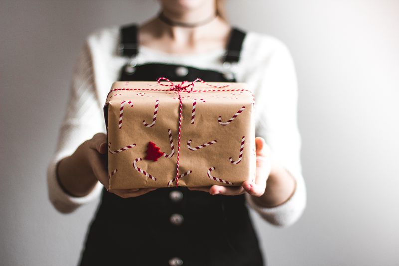 A woman holding up a gift box