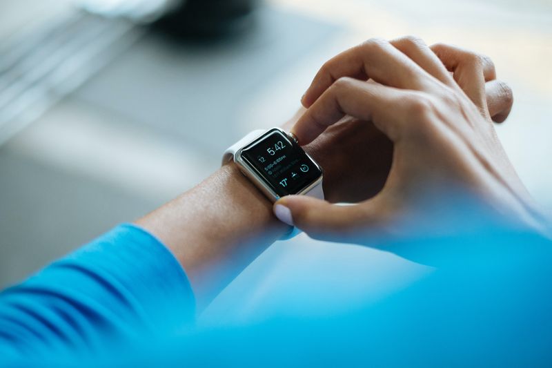 A woman adjusts her smart watch.