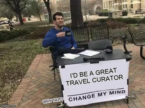 A man at a table with a sign that reads, 'I'd be a great travel curator. Why not? Change my mind.'