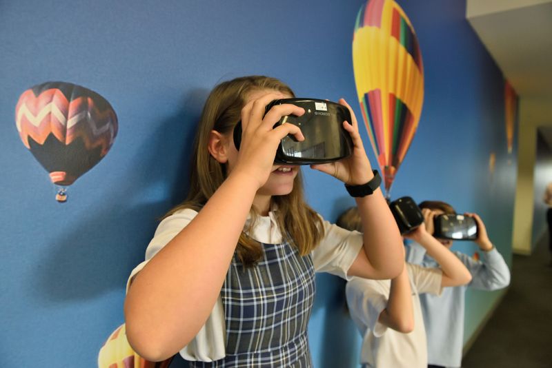 Students using virtual reality goggles.