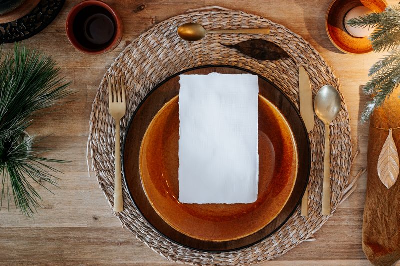 Empty place setting at a table decorated for the holidays.