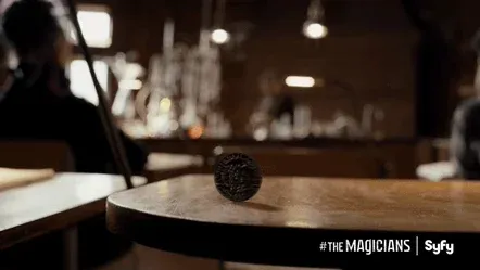 A person doing a magic trick with a coin.