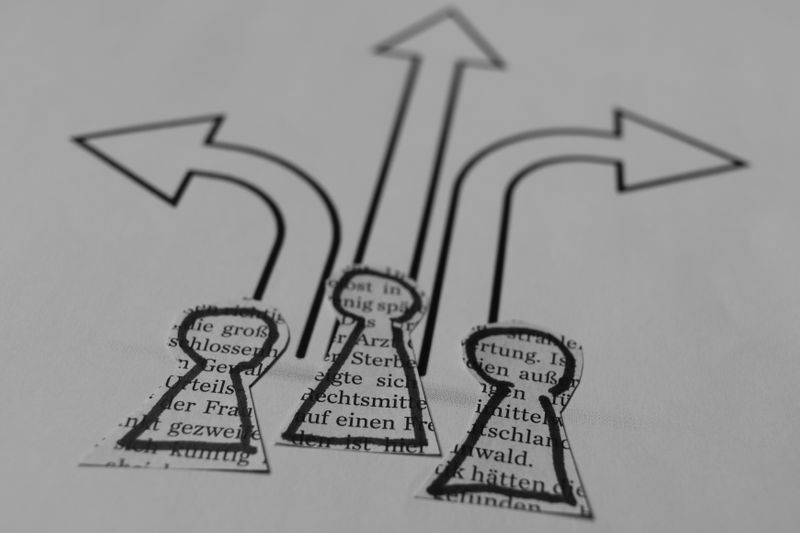 Paper cut‑out figures with arrows showing different possible directions.
