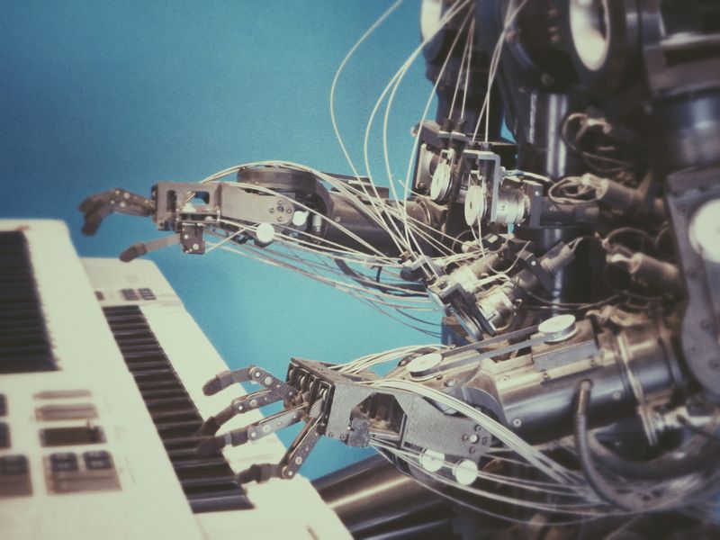 A futuristic robot playing the piano.